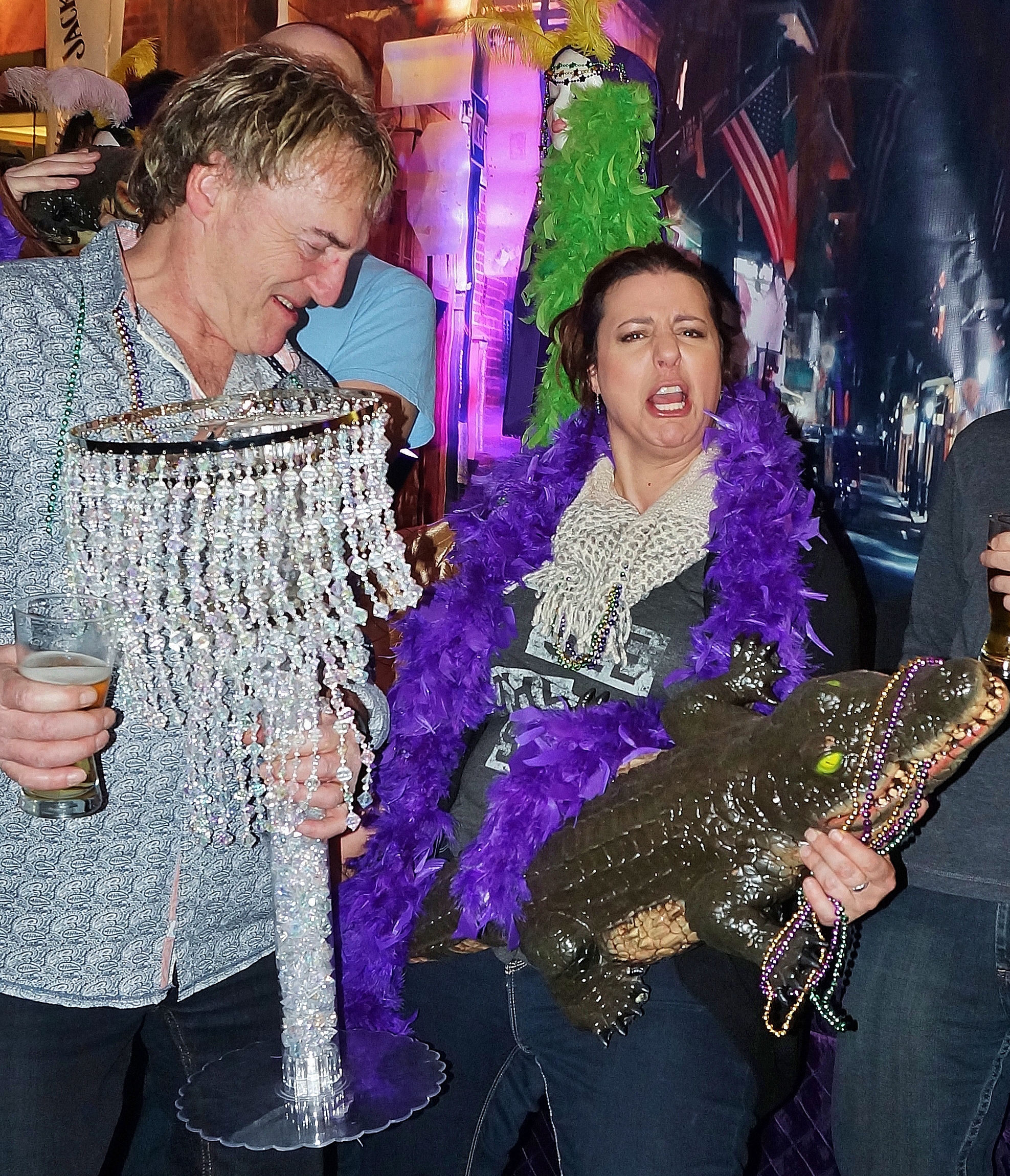 Tom McGouran lampshade at the ready with Alix Michaels rocking out with an Aligator at Mardi Gras Media Night